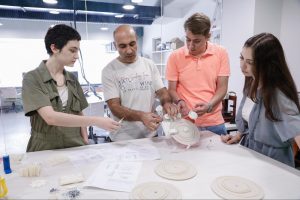  Prototyping Lab engineer Arman Asatryan helps AUA students assemble student-designed mechanisms manufactured using the CNC milling machine and 3D printer. 